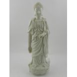 A Chinese blanc de chine hard paste porcelain figural study of Guanyin, raised on a lotus base. H.