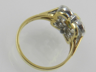 An 18 carat yellow gold, diamond, and emerald set ring of quatrefoil form. - Image 2 of 2