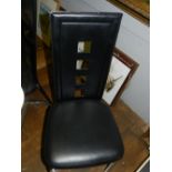 A set of six faux leather and chrome dining chairs.