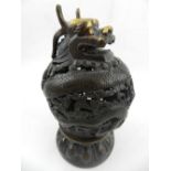 A Chinese bronze incense burner, pierced and carved as a dragon, bears character mark to base. H.