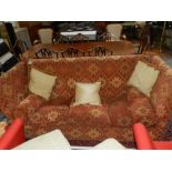 A contemporary Knole-end three seater sofa, upholstered in geoemetric designed terracotta fabric,