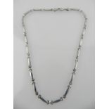 A white metal articulated link necklace, the clasp stamped 375.