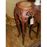 A Chinese marble top bamboo jardiniere stand, having carved pierced decoration,