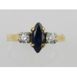 A yellow metal, sapphire, and diamond set three stone ring,