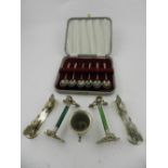 A cased set of six silver spoons, together with two pairs of white metal knife rests.