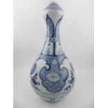 A Chinese blue and white pear shaped vase, decorated with stylised leaves and waves. H.