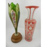 A Bohemian green glass vase, painted with panels of flowers on gilt foliate ground,