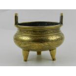 A Chinese brass twin-handled incense burner, decorated with dragons and flowers,