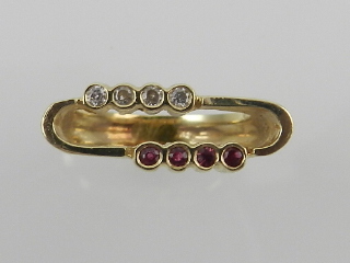 An unusual yellow metal, diamond, and ruby ring, in the Modernist taste,