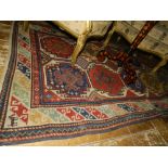 An Afghan rug, having two rows of elephant pad motif to centre, multi-bordered and fringed. L.