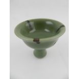 A Chinese hard paste porcelain celadon stem bowl. H.8cm.