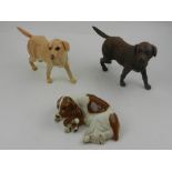 Two Royal Doulton studies of retrievers, together with a study of a spaniel and puppy. (3)