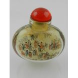 A Chinese glass snuff bottle, intaglio decorated with figures.