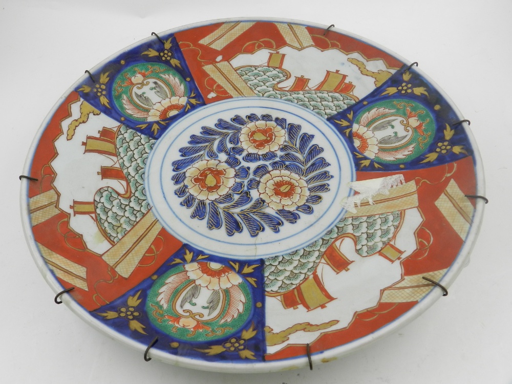 A Japanese Imari charger, decorated with stylised waves and flowers. D.