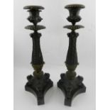 A pair of 19th century bronze candlesticks, in the form of three paw tri-form feet. H.