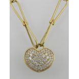 A yellow metal and diamond set heart pendant, suspended on an unusual fixed twist link chain,