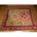 A Caucasian olive ground rug, having two pole medallion, with octagonal medallion,
