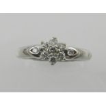 An 18 carat white gold and diamond set floral cluster ring, the stones of approx. 0.