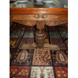 A late 19th century oak extending dining table, raised on trefoil legs.