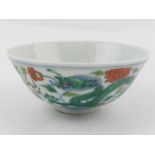 A Chinese ducai tea bowl, decorated with dragons chasing a flaming pearl,