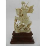 A late 19th century ivory figurine of a warrior battling a dragon.