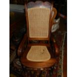 A pair of mahogany framed rocking chairs with caned seat and backs.