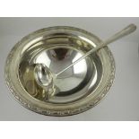 A silver plated punch bowl twelve cups, and a ladle.