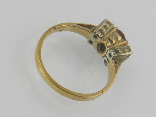 A yellow metal, diamond, and red stone (possibly ruby) ring. - Image 2 of 2