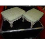 A pair of French carved and painted walnut low stools, having stuffover upholstered seats,