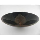 A Chinese jizhou kiln bowl, decorated with leaf to interior on a brown drip glaze ground.