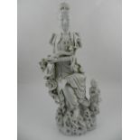 A Chinese blanc de chine figural study of Guanyin with a child servant in attendance. H: 36cm