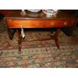 A Regency style mahogany sofa table, having two drop ends, fitted two single drawers,