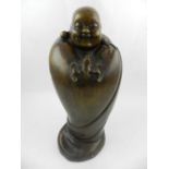 A Chinese bronze figural study of a Buddha in a cape, having mounted bat,