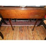 A Victorian mahogany pembroke table, raised on chamfered tapered legs, with flared feet.