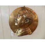 A copper plaque relief decorated with profile portrait of a gentleman.