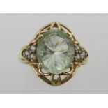 A yellow metal and green amethyst ring, the central stone in an openwork mount,
