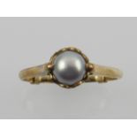 A 9 carat yellow gold ring set with a pearl.
