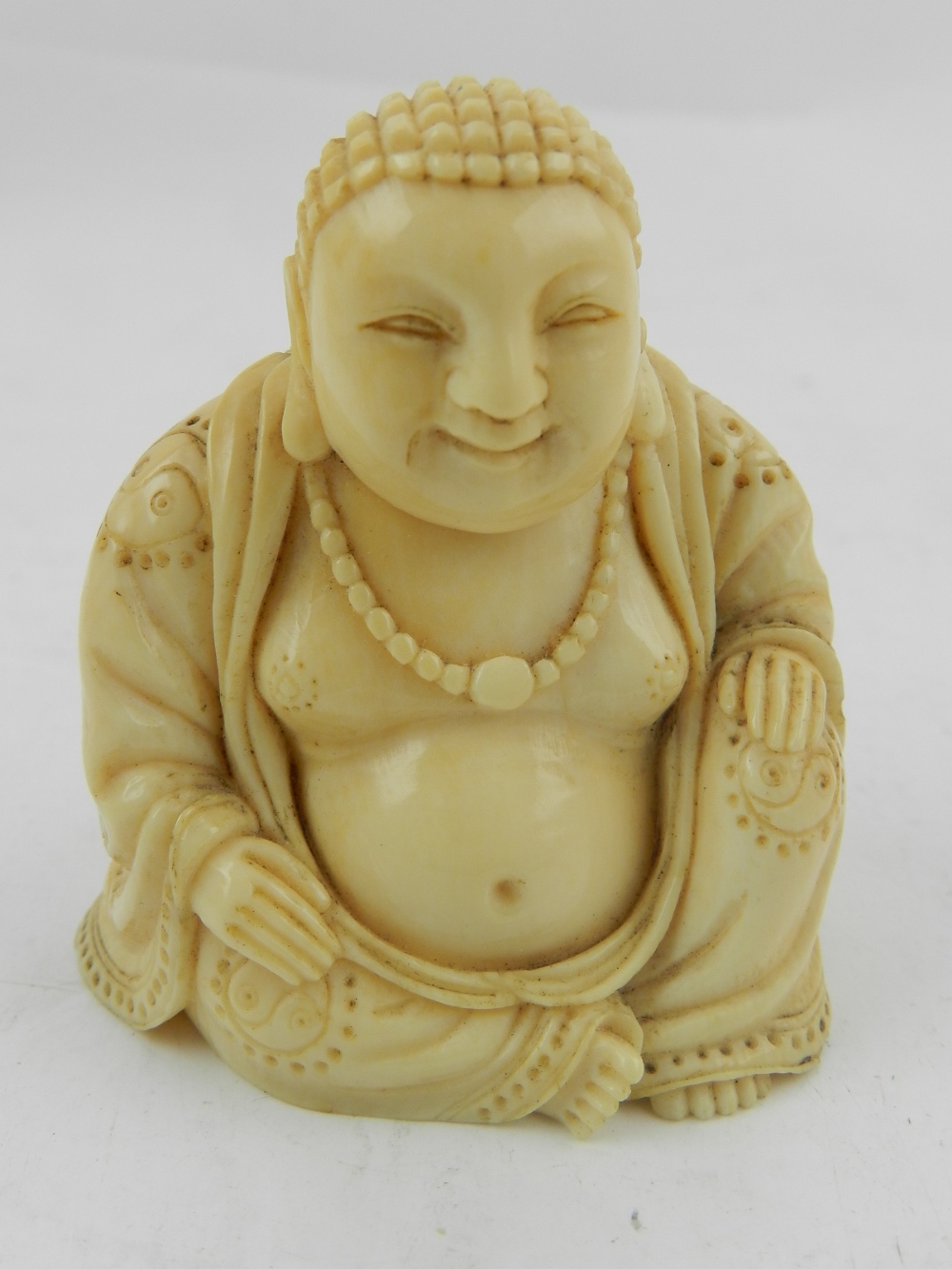 A Chinese ivory study of a seated Buddha.