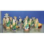 A collection of fifteen Tang style pottery figures, in blue, yellow and green glazes,