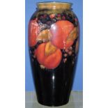William Moorcroft pomegranate pattern vase, of tall baluster form decorated on a deep blue ground,