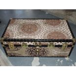 A rectangular brass mounted steamer trunk with patterned brown fabric outer cover, W. 90cm.