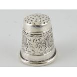 A white metal thimble, decorated with a foliate band, marked 925.