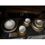 A 24 piece Continental porcelain tea service for six decorated with scrolling gilt bands.