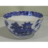A blue and white decorated bowl, of ribbed form, showing a landscape scene, D. 11cm.