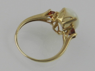 A 9 carat yellow gold, opal, and garnet ring. - Image 2 of 2