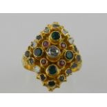 An unusual yellow metal, emerald, ruby, and diamond ring,