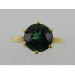 A 9 carat yellow gold and single stone green tourmaline ring.