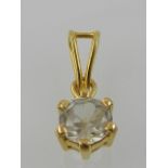 A yellow metal and white zircon set pendant, with yellow metal suspension loop.