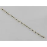 An 18ct gold diamond line bracelet, with baguette oval links, total weight 2ct, L. 19cm.