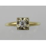 A yellow metal and diamond ring, set single stone, the shank stamped 14K.